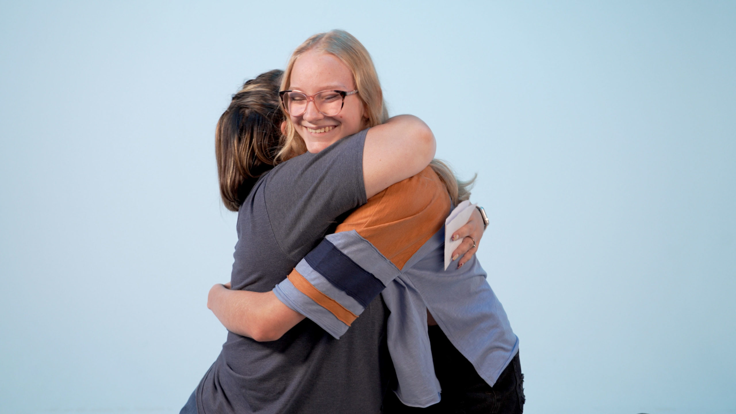 Staff Member Melissa hugs a student after encouraging them in their walk with Jesus