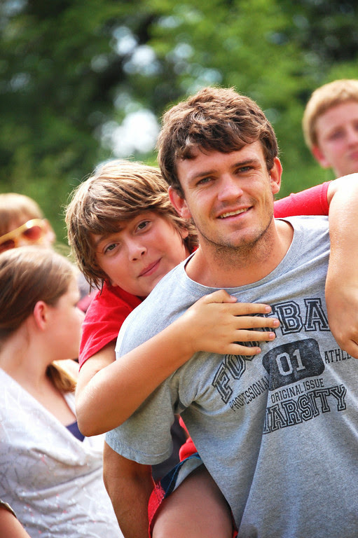 Brian a yfc leader gives a boy a piggy back ride